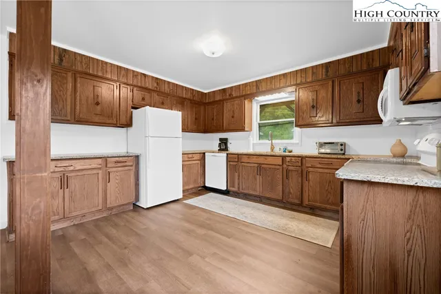 a kitchen with a sink a window and cabinets