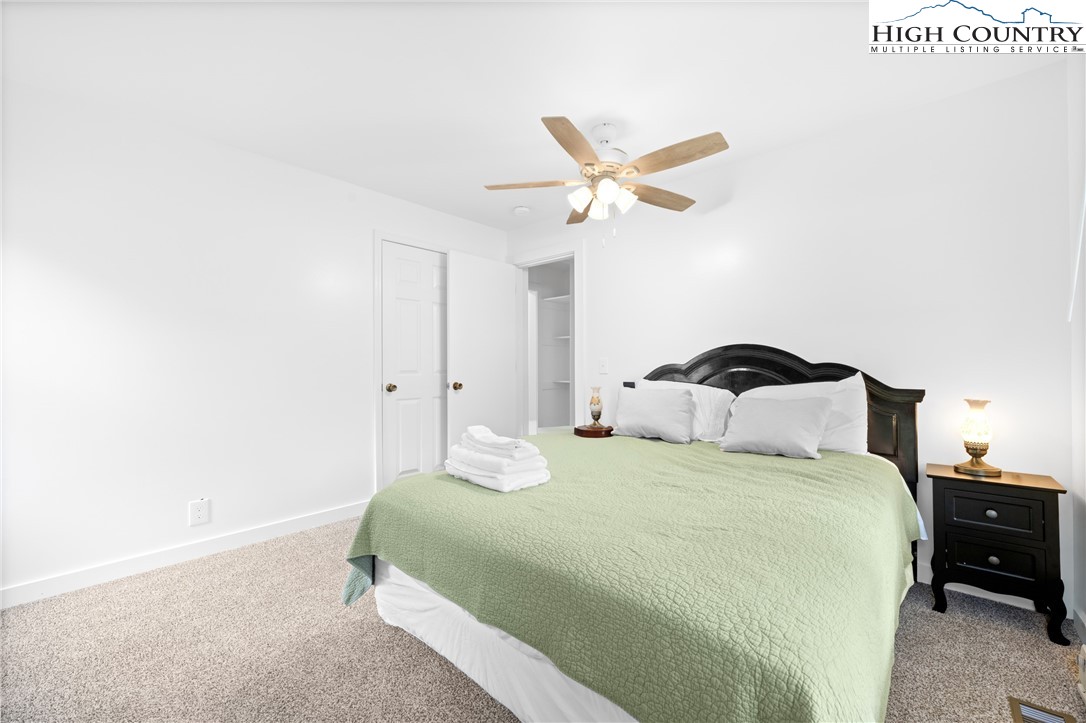 1044 Highway 321 Vilas, NC 28692 - Photo 23 of 47 a bedroom with a bed and a chandelier