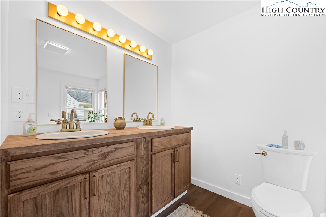 1044 Highway 321 Vilas, NC 28692 - Photo 24 of 47 a bathroom with a toilet a sink and mirror