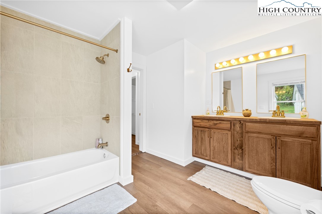 1044 Highway 321 Vilas, NC 28692 - Photo 25 of 47 a bathroom with a tub sink and mirror