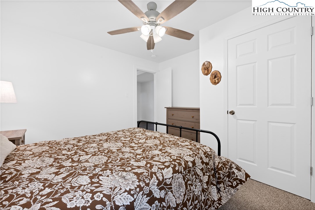 1044 Highway 321 Vilas, NC 28692 - Photo 28 of 47 a bedroom with a bed and a chandelier