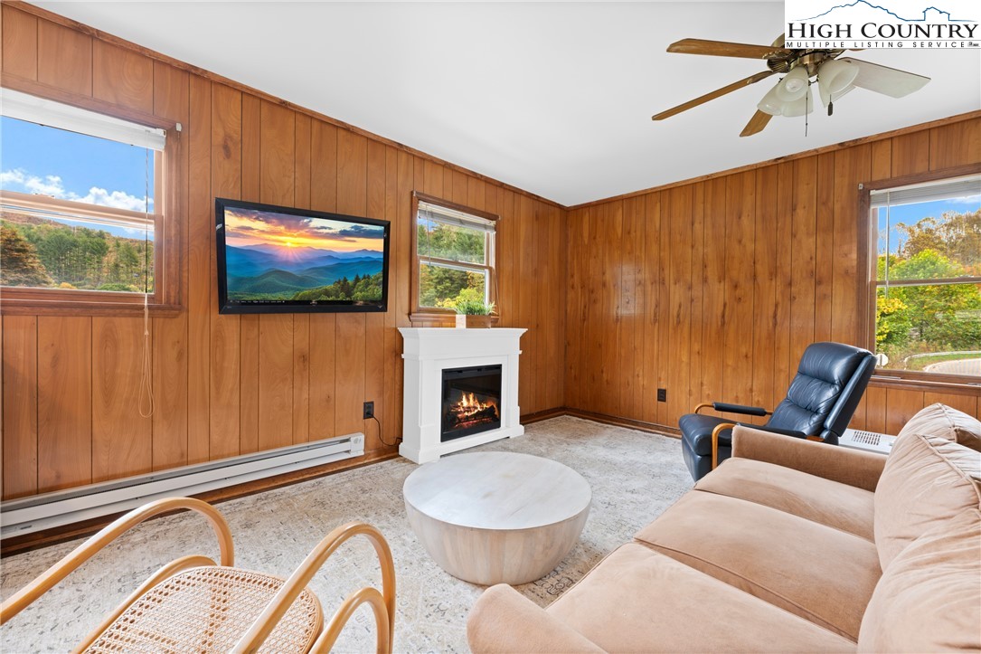 1044 Highway 321 Vilas, NC 28692 - Photo 32 of 47 a living room with furniture a flat screen tv and a fireplace