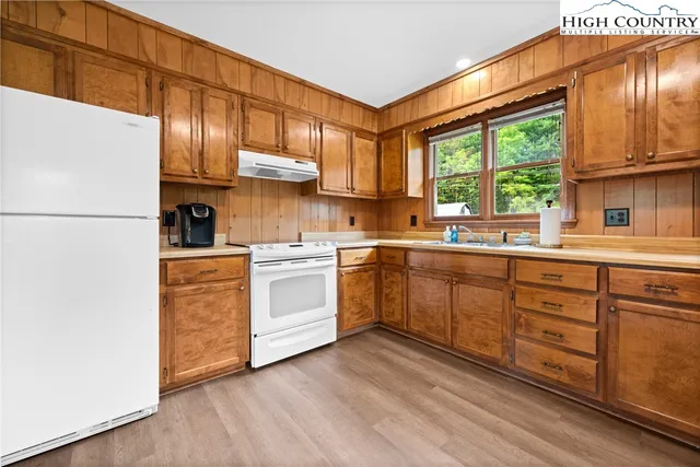 a kitchen with a sink appliances cabinets and a kitchen