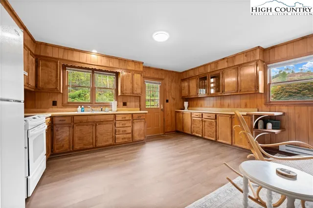 a kitchen with granite countertop a sink stainless steel appliances and white cabinets