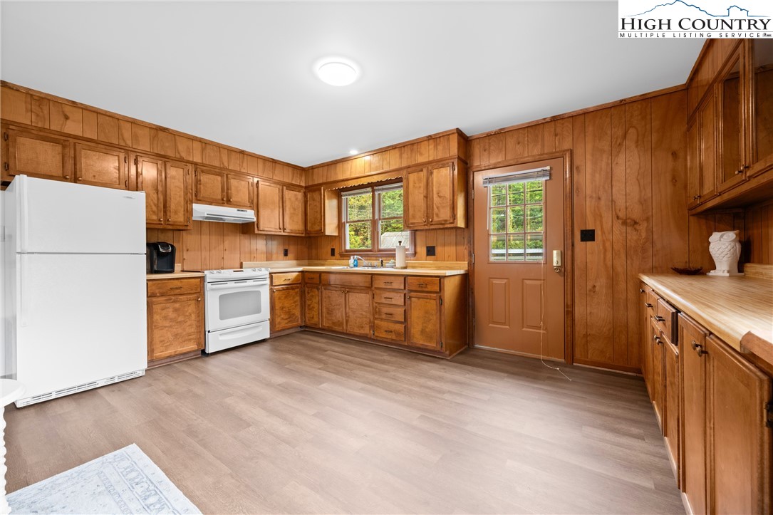 1044 Highway 321 Vilas, NC 28692 - Photo 35 of 47 a kitchen with granite countertop a sink stainless steel appliances and white cabinets