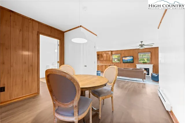 a dining room with furniture and wooden floor