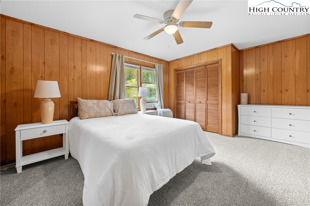 1044 Highway 321 Vilas, NC 28692 - Photo 38 of 47 a bedroom with a large bed and a chandelier