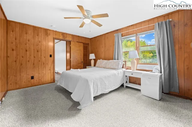 a bedroom with a large bed and a large window