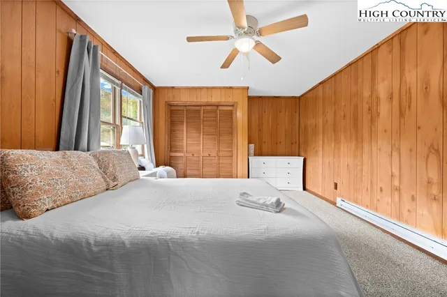 a spacious bedroom with a bed and a window