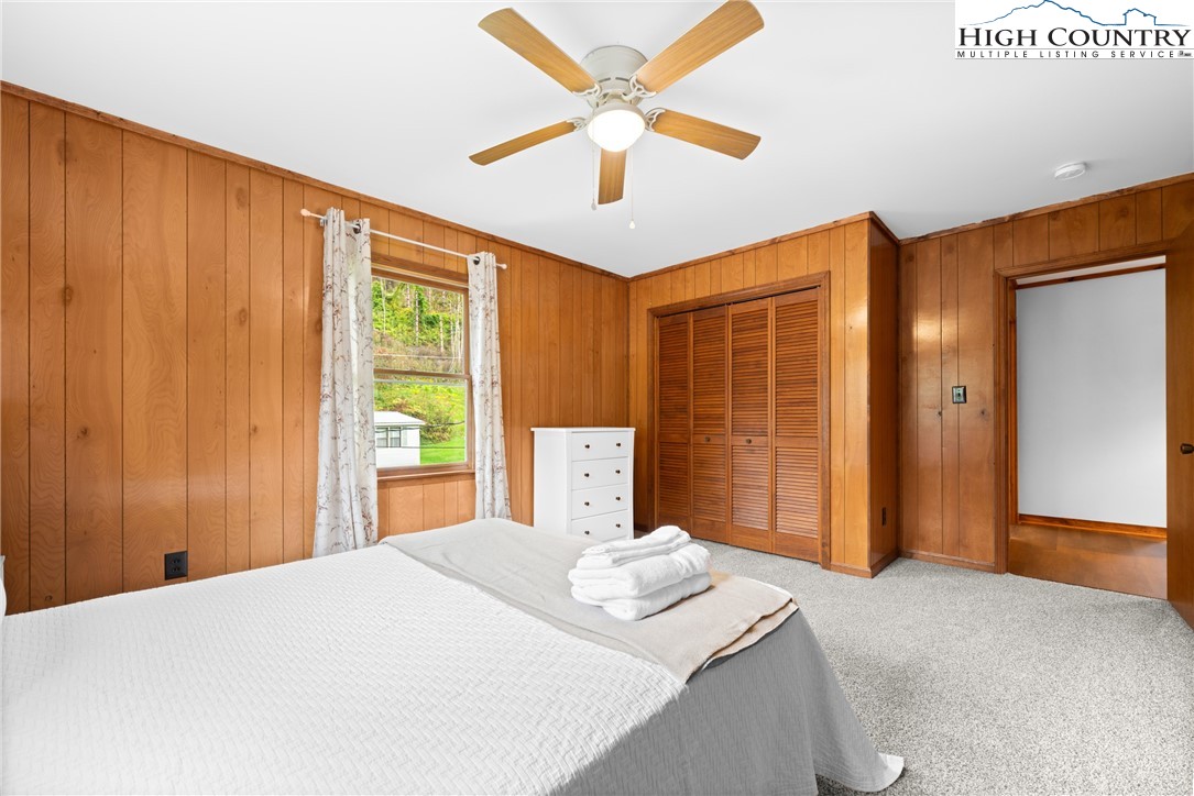 1044 Highway 321 Vilas, NC 28692 - Photo 42 of 47 a bedroom with a large bed and a chandelier