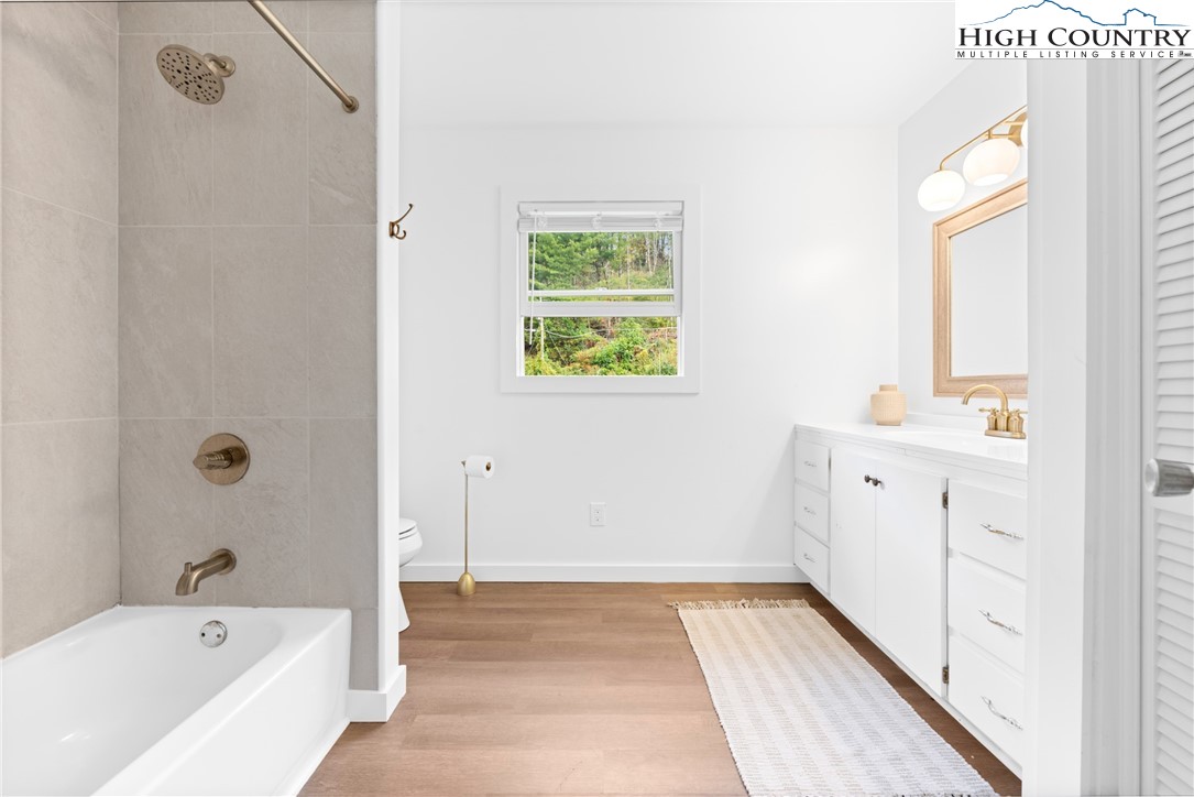 1044 Highway 321 Vilas, NC 28692 - Photo 43 of 47 a bathroom with a bathtub sink and mirror