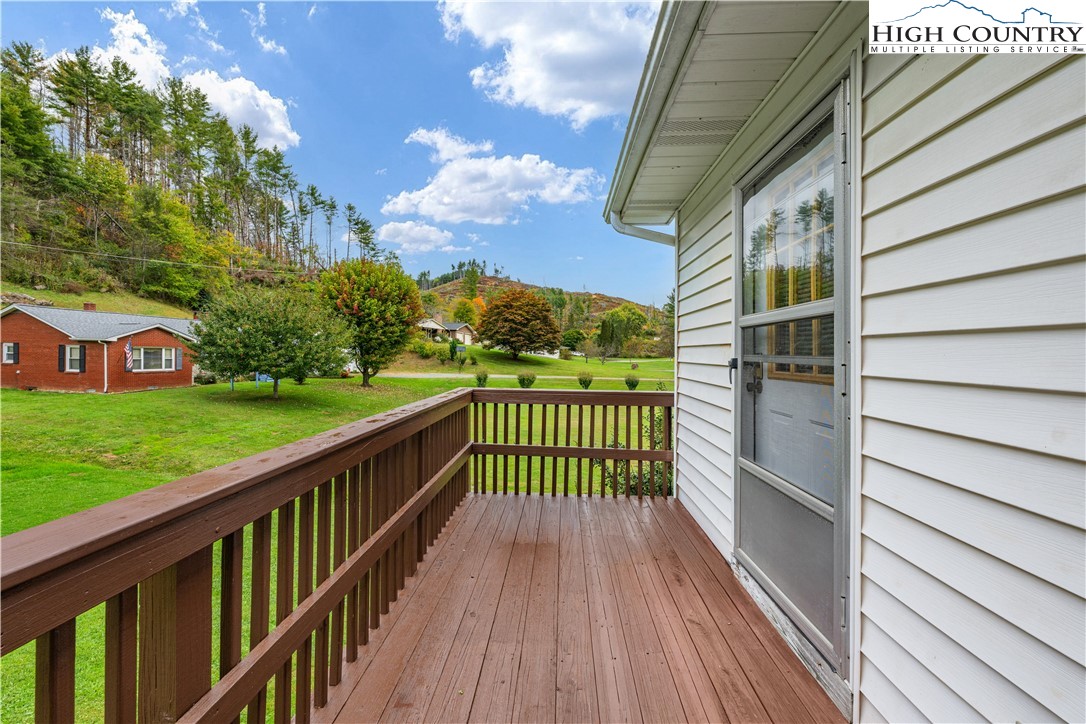 1044 Highway 321 Vilas, NC 28692 - Photo 46 of 47 a view of a wooden deck with a yard