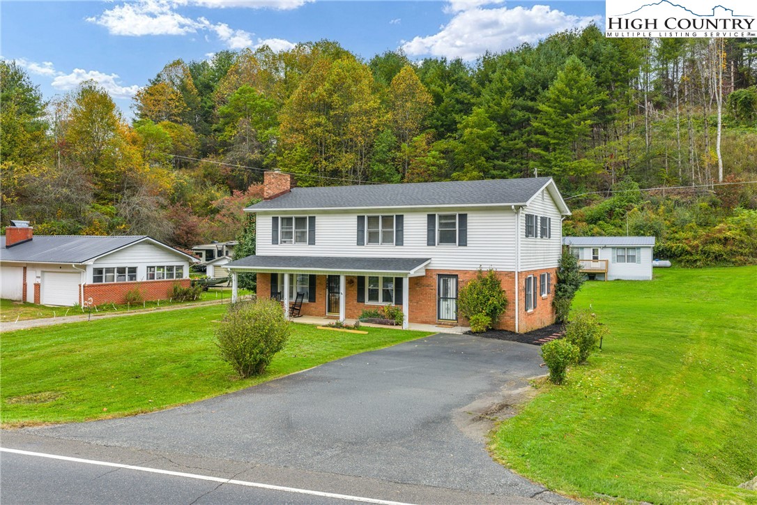 1044 Highway 321 Vilas, NC 28692 - Photo 6 of 47 a front view of a house with a garden