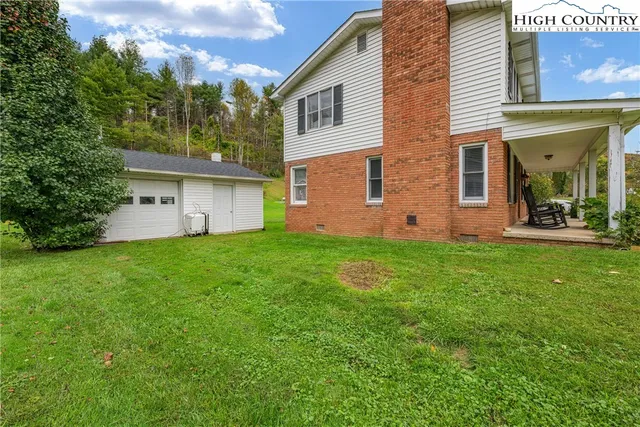 a view of a house with backyard and porch