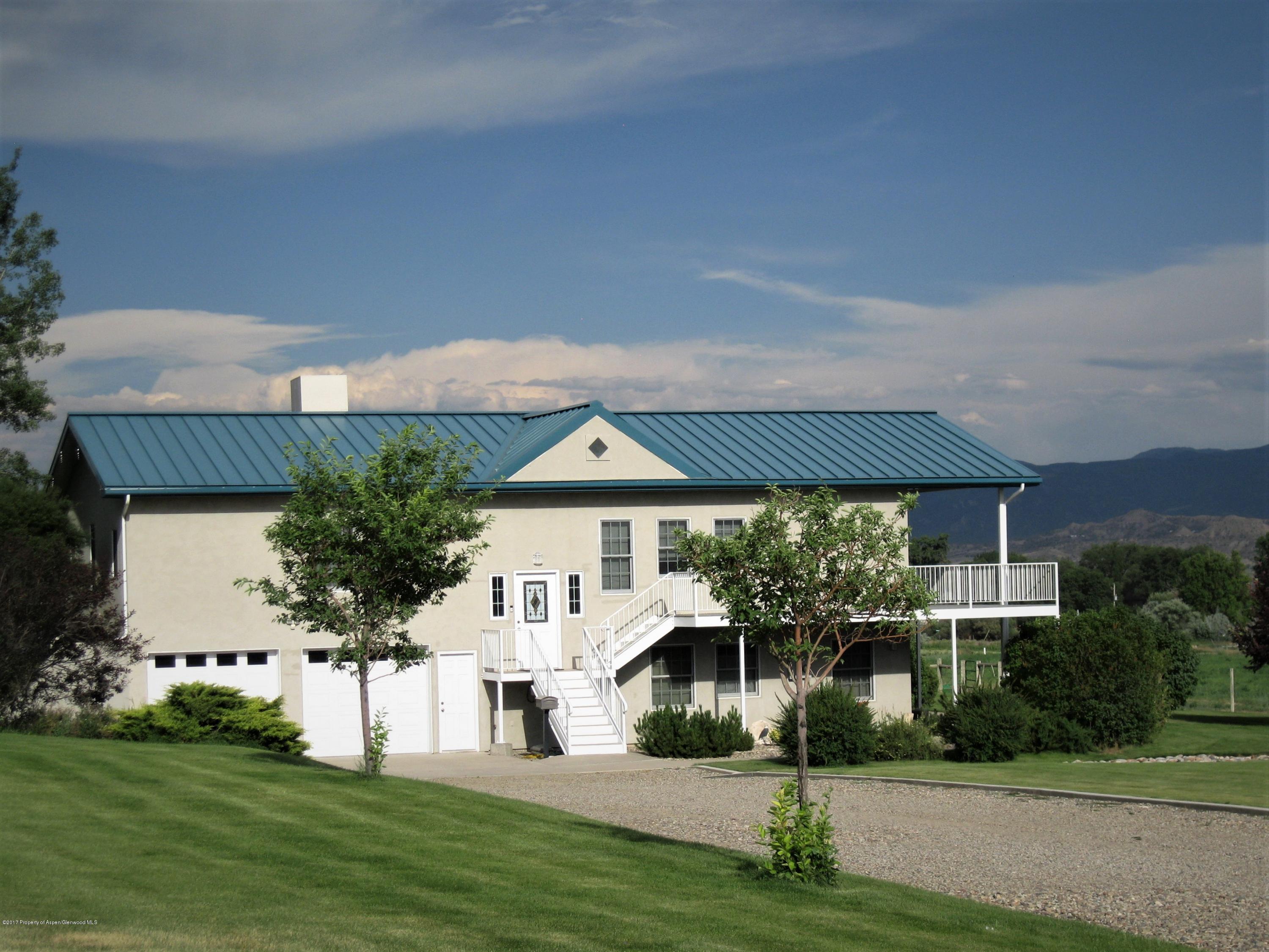 2989 County Road 210 Rifle, CO 81650 - Photo 4 of 22 a front view of a house with a yard