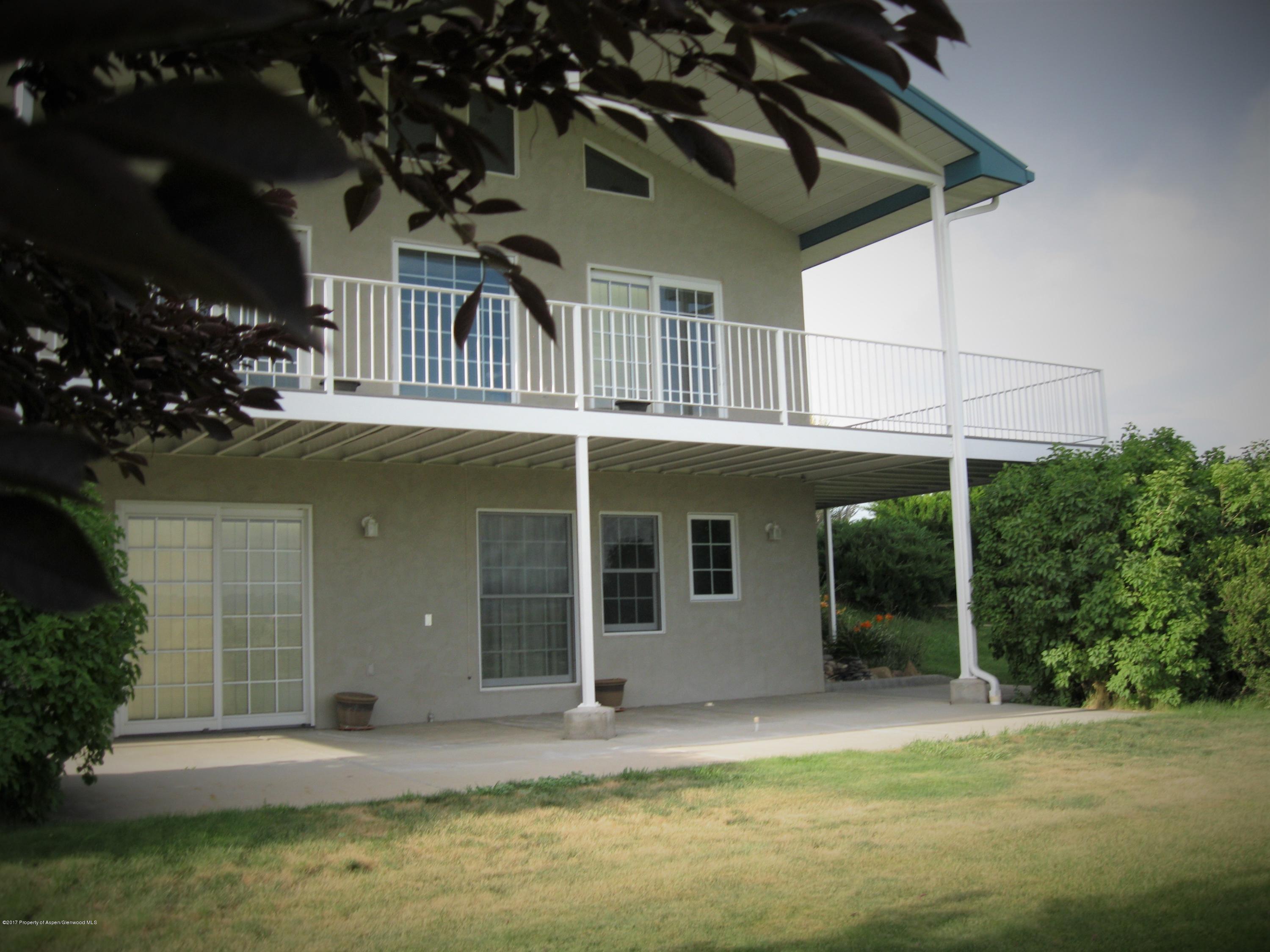 2989 County Road 210 Rifle, CO 81650 - Photo 6 of 22 a front view of a house with a porch