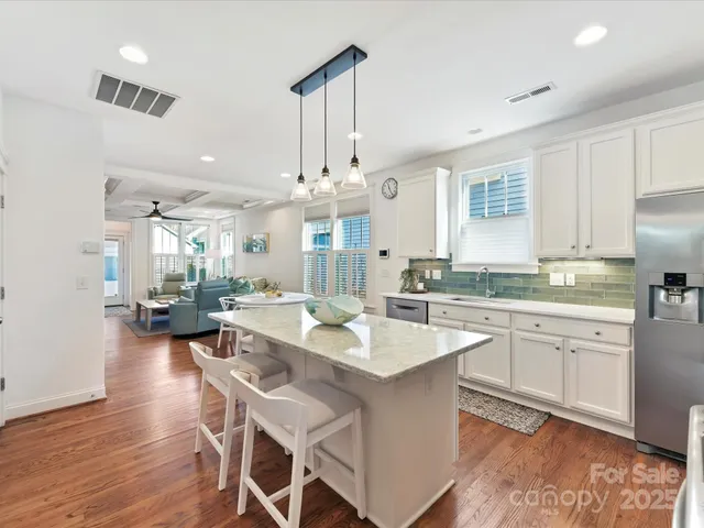 a large kitchen with a table and chairs