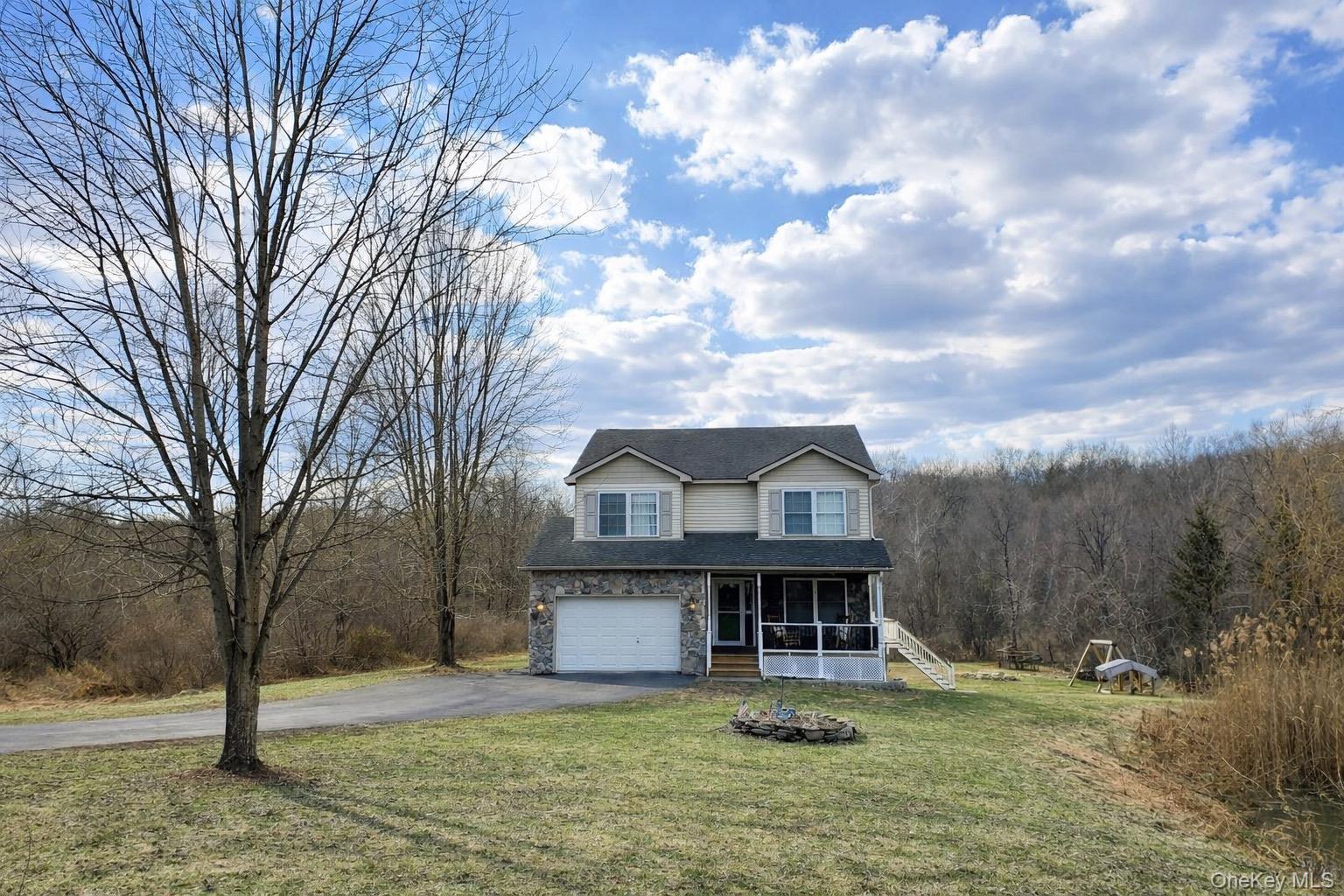 a view of a big house with a big yard and large tree