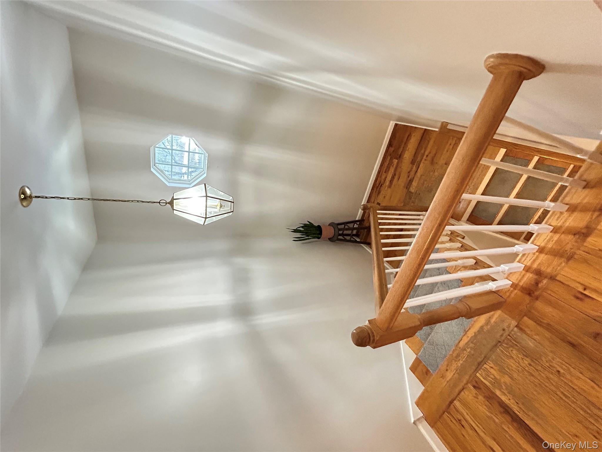 53 Daly Road Middletown, NY 10940 - Photo 12 of 27 a view of a balcony wooden floor and a chandelier