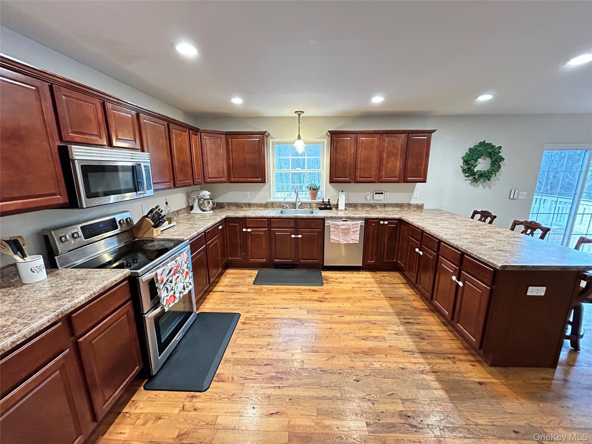 53 Daly Road Middletown, NY 10940 - Photo 9 of 27 a large kitchen with stainless steel appliances granite countertop wooden cabinets a sink dishwasher a stove and a refrigerator