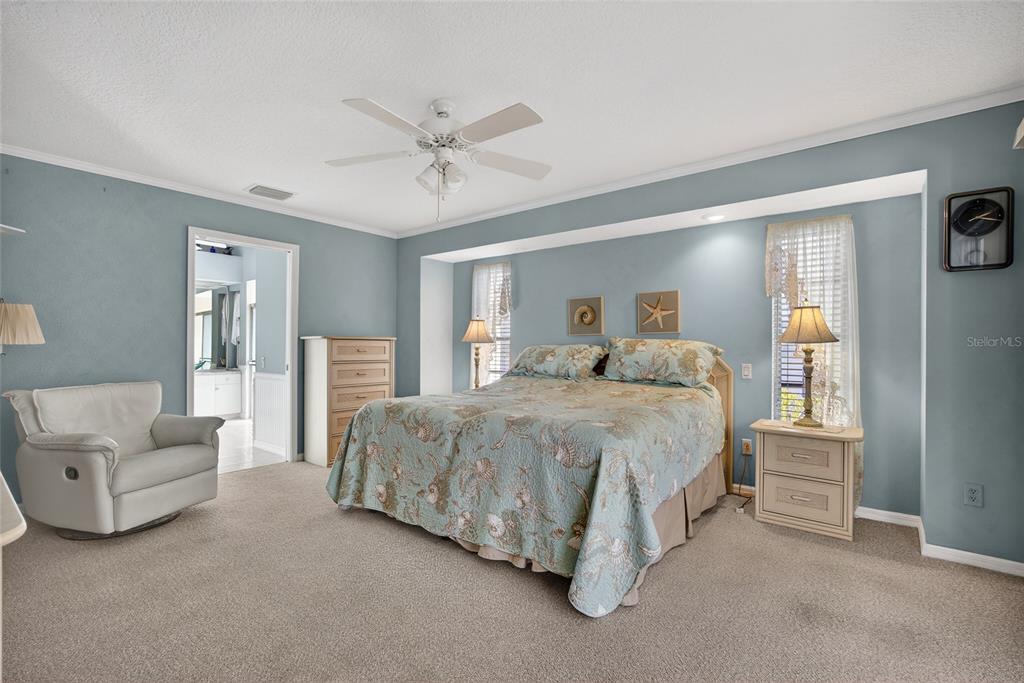 1421 Rio De Janeiro Avenue Punta Gorda, FL 33983 - Photo 13 of 34 a spacious bedroom with a bed and a couch