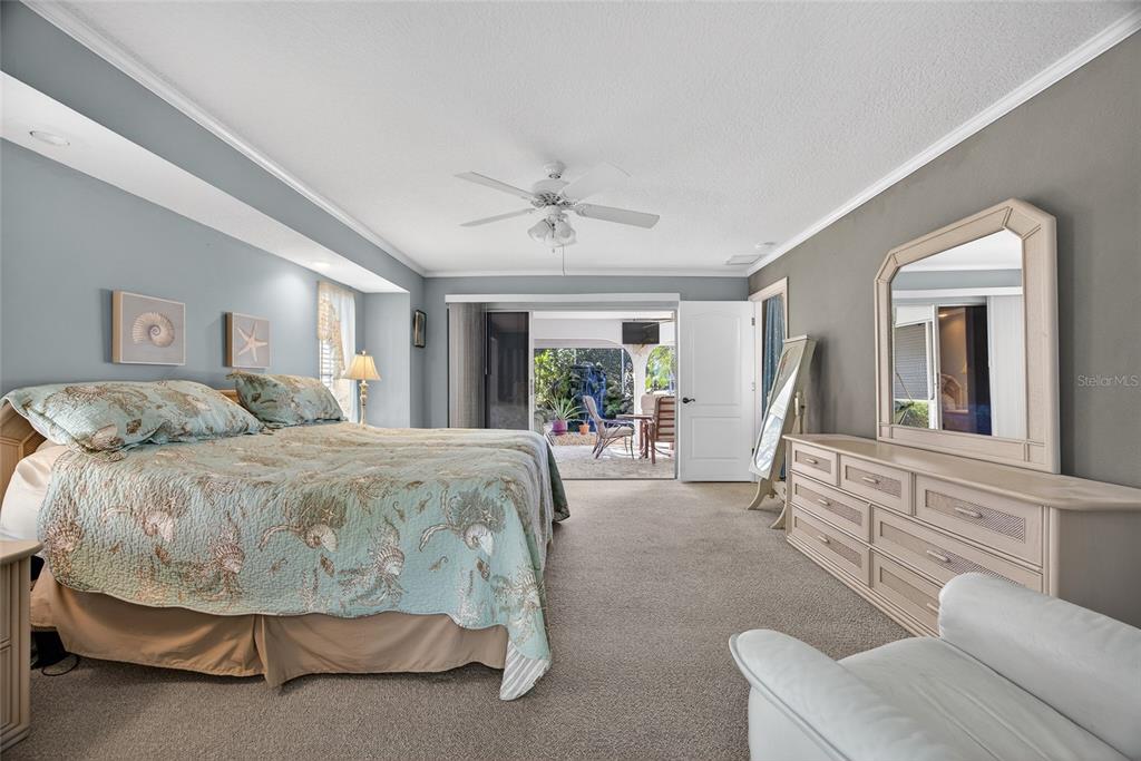 1421 Rio De Janeiro Avenue Punta Gorda, FL 33983 - Photo 14 of 34 a spacious bedroom with a bed a mirror and a large window