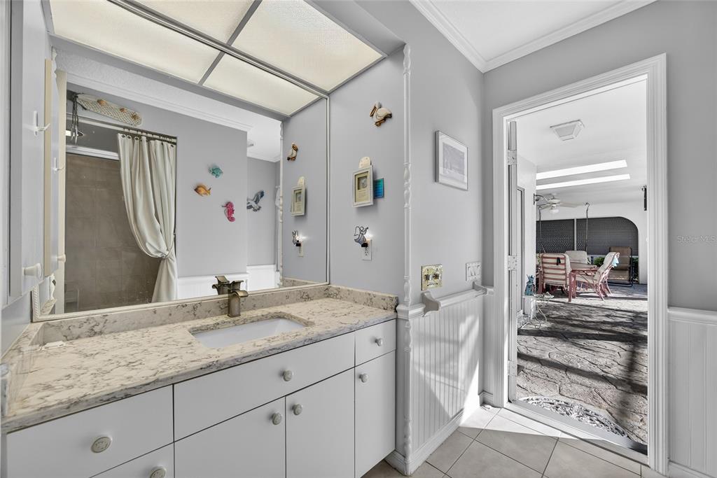 1421 Rio De Janeiro Avenue Punta Gorda, FL 33983 - Photo 19 of 34 a en suite bathroom with a granite countertop sink and a mirror