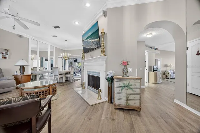 a living room with furniture fireplace and wooden floor