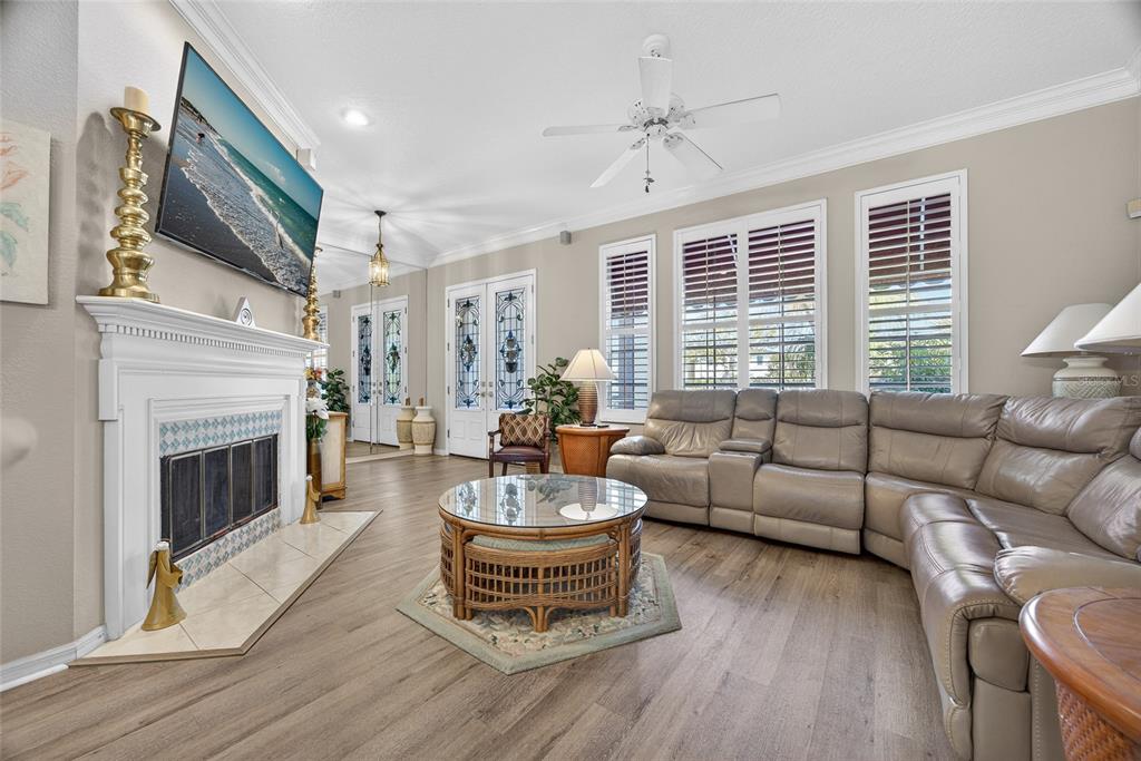 1421 Rio De Janeiro Avenue Punta Gorda, FL 33983 - Photo 4 of 34 a living room with furniture a fireplace and a large window