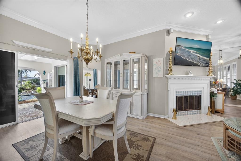 1421 Rio De Janeiro Avenue Punta Gorda, FL 33983 - Photo 5 of 34 a view of a dining room with furniture wooden floor and chandelier