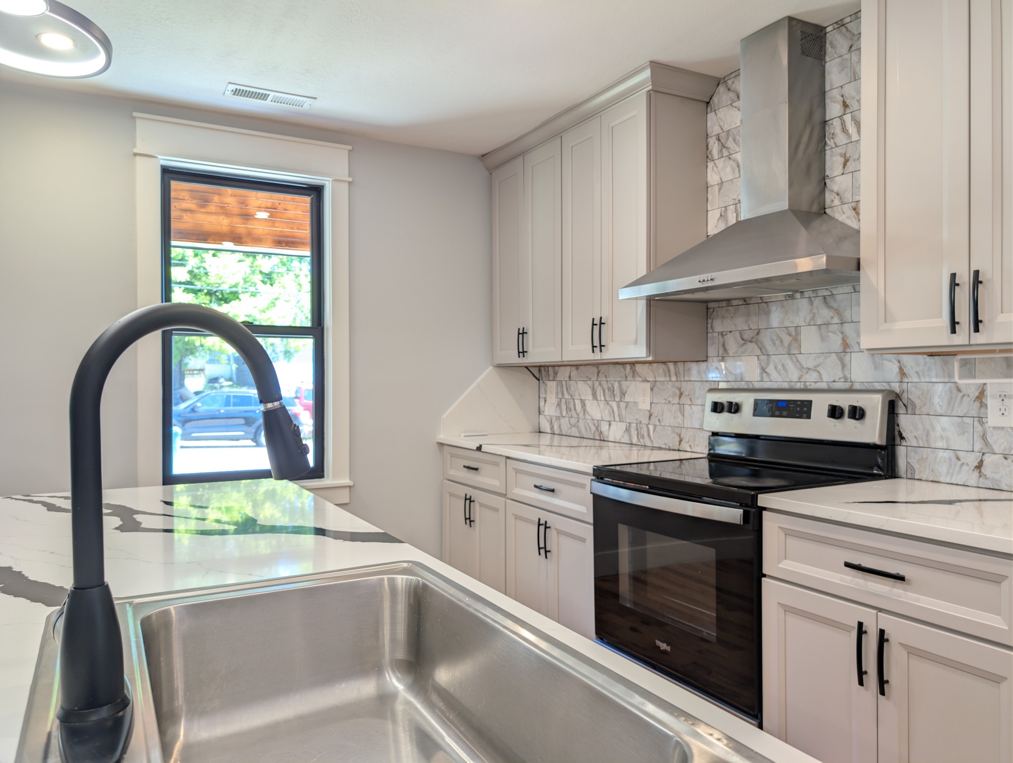 244 Warrior Road Madison, TN 37115 - Photo 6 of 24 a kitchen with stainless steel appliances a stove sink and cabinets