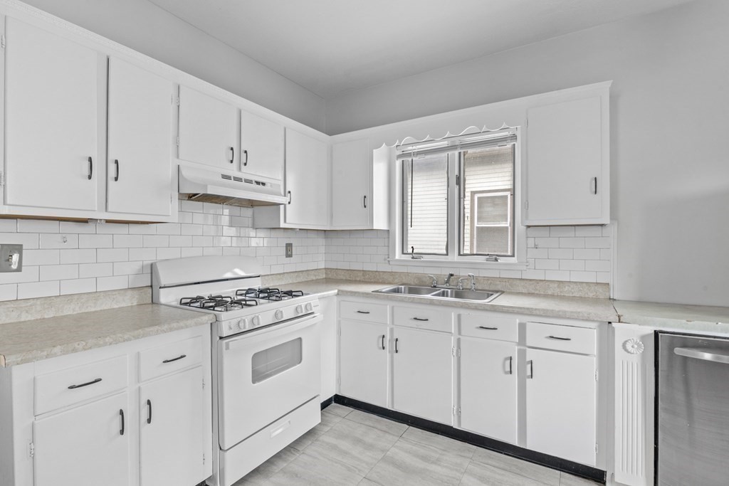 47 Cedar Street Malden, MA 02148 - Photo 13 of 24 a kitchen with white cabinets white appliances and sink