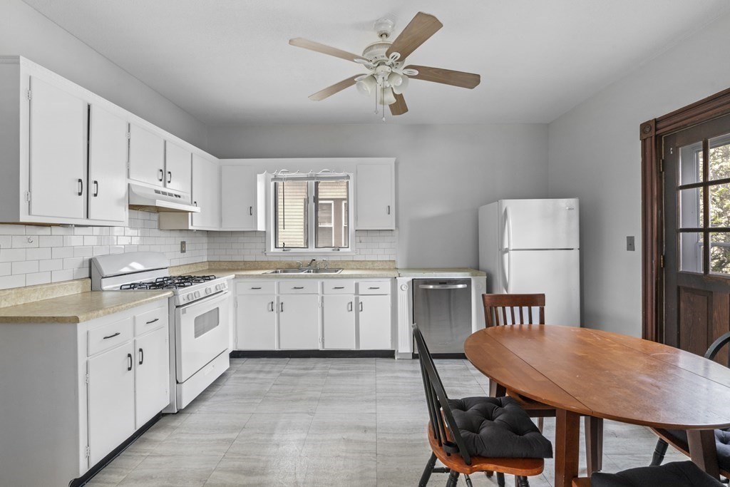 47 Cedar Street Malden, MA 02148 - Photo 14 of 24 a kitchen with cabinets appliances and a center island