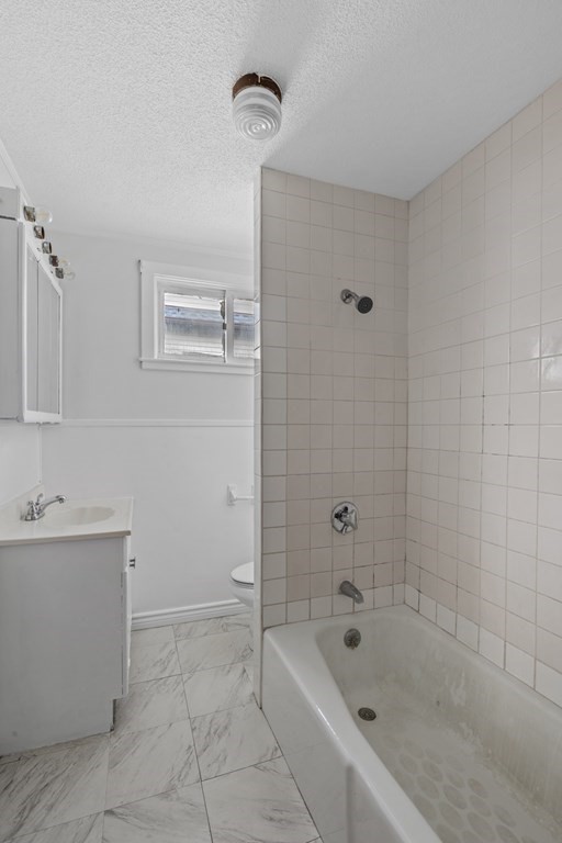 47 Cedar Street Malden, MA 02148 - Photo 17 of 24 a bathroom with a bathtub and mirror