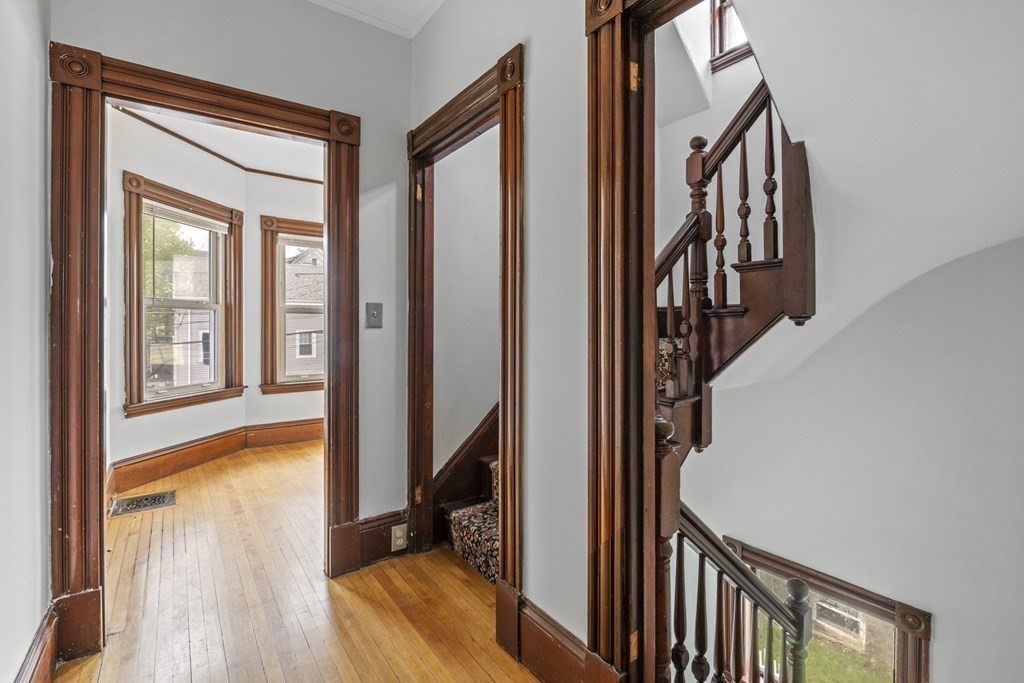 47 Cedar Street Malden, MA 02148 - Photo 19 of 24 a view of a hallway with wooden floor and staircase