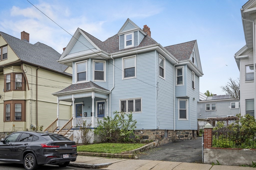 47 Cedar Street Malden, MA 02148 - Photo 3 of 24 a front view of a house with a garden