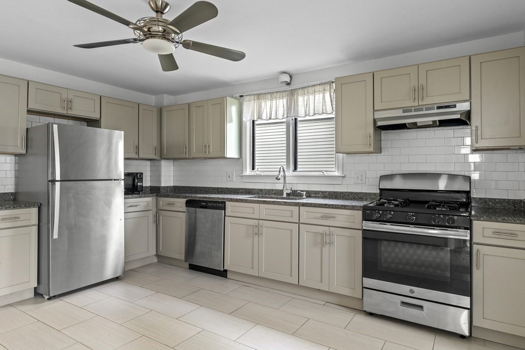 47 Cedar Street Malden, MA 02148 - Photo 4 of 24 a kitchen with cabinets stainless steel appliances and a window