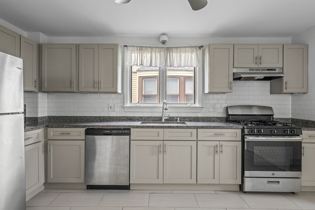 47 Cedar Street Malden, MA 02148 - Photo 5 of 24 a kitchen with white cabinets and white appliances