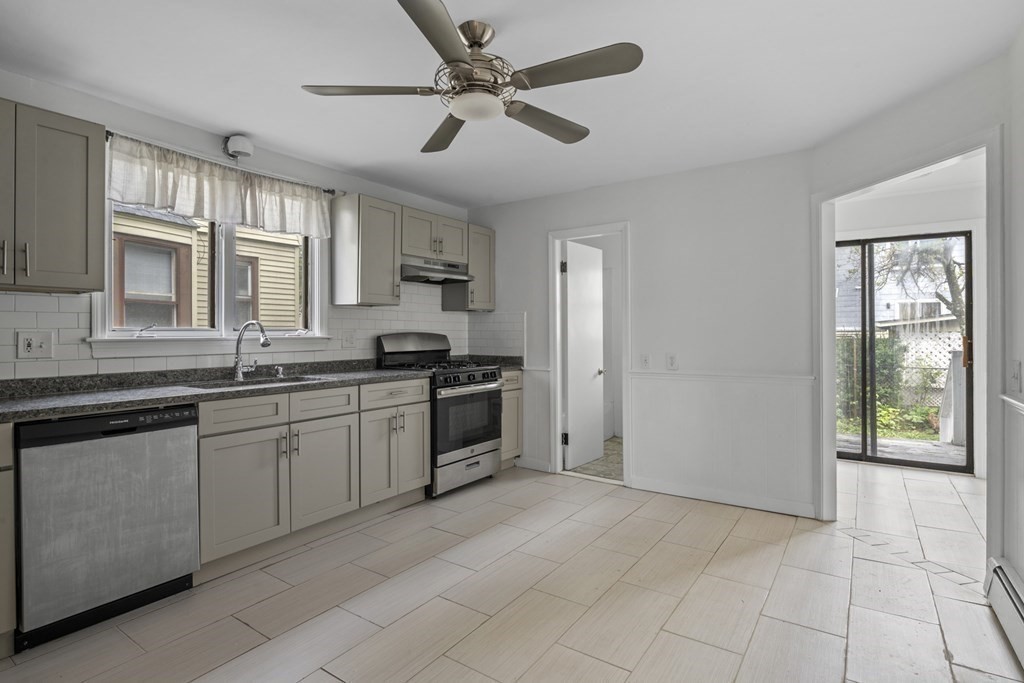 47 Cedar Street Malden, MA 02148 - Photo 6 of 24 a kitchen with granite countertop a refrigerator cabinets and a sink