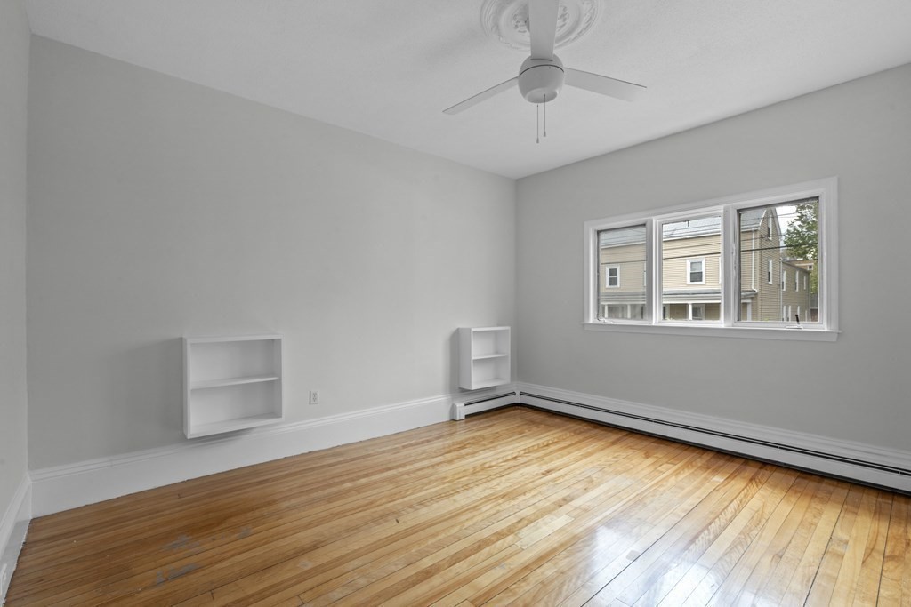 47 Cedar Street Malden, MA 02148 - Photo 10 of 24 a room with window and wooden floor