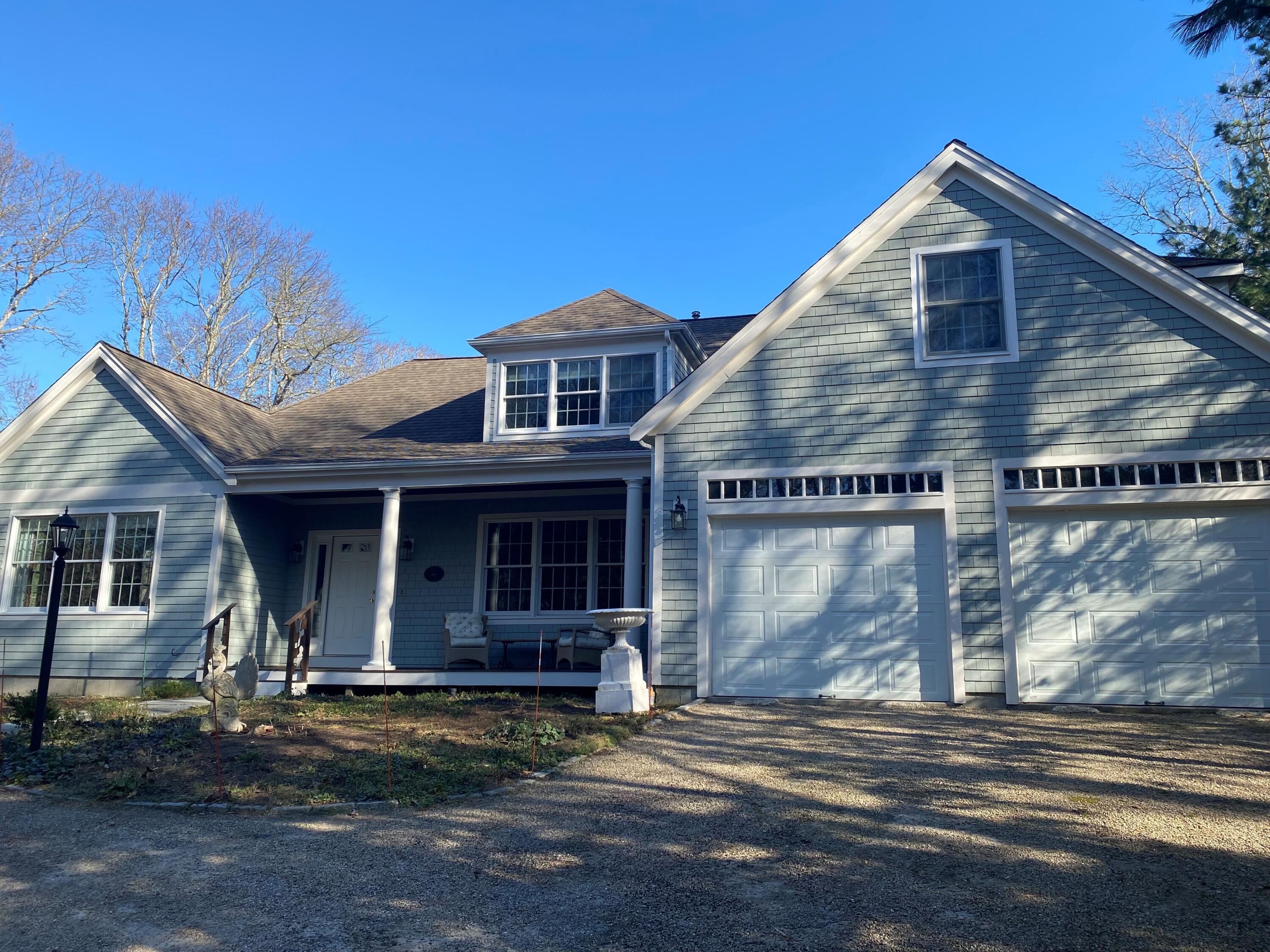 208 Rock Landing Road Mashpee, MA 02649 - Photo 1 of 32 a front view of a house with garden
