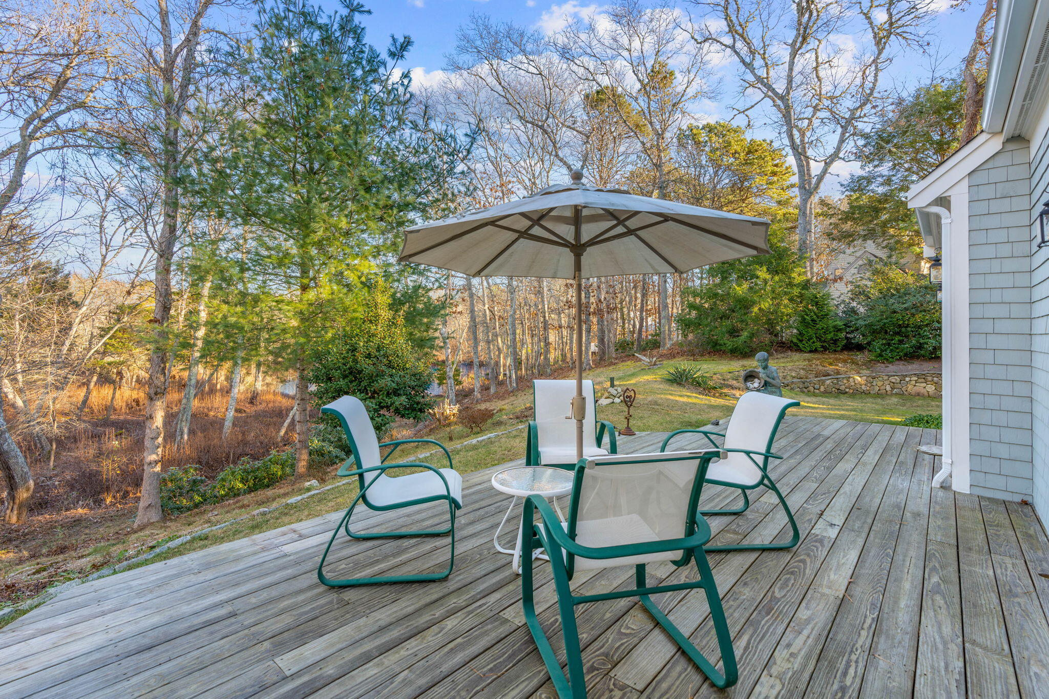 208 Rock Landing Road Mashpee, MA 02649 - Photo 13 of 32 a view of a chairs and table on the wooden deck