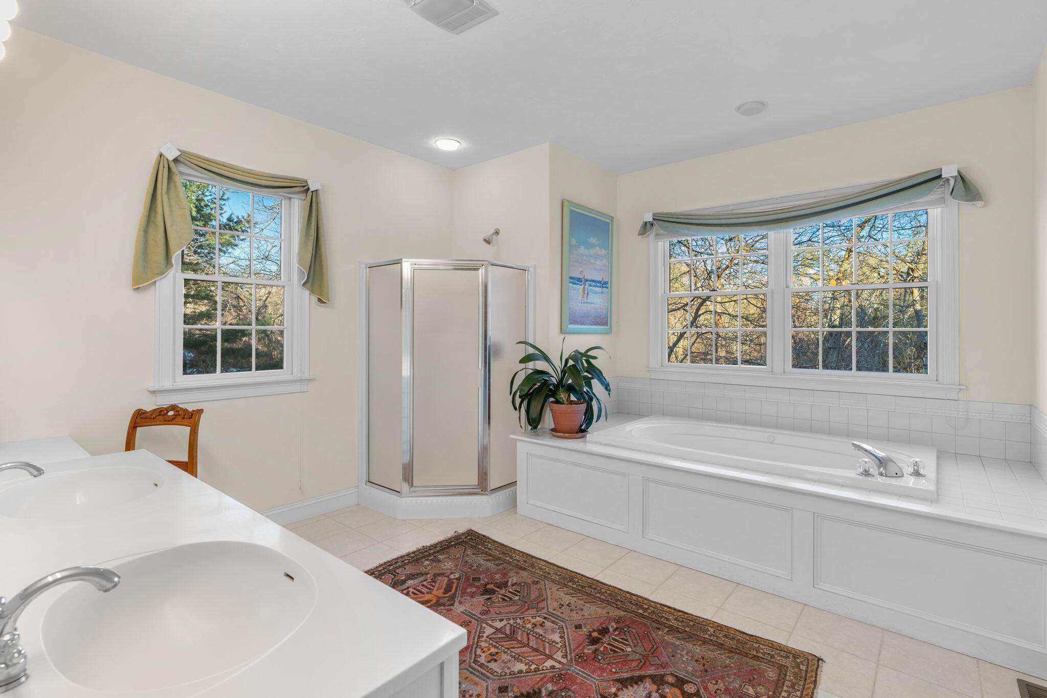 208 Rock Landing Road Mashpee, MA 02649 - Photo 20 of 32 a bathroom with a sink a bathtub and a window