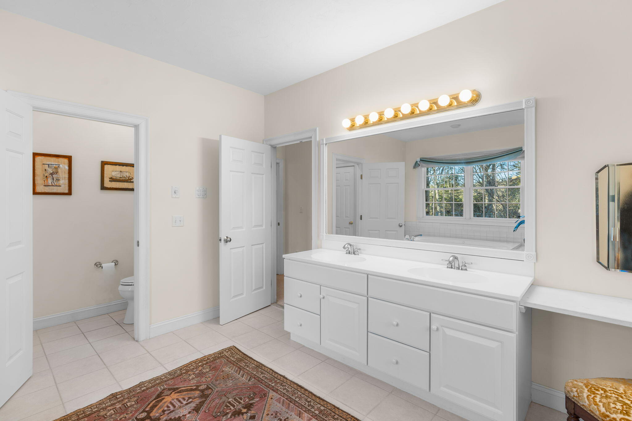 208 Rock Landing Road Mashpee, MA 02649 - Photo 21 of 32 a spacious bathroom with a shower sink and mirror