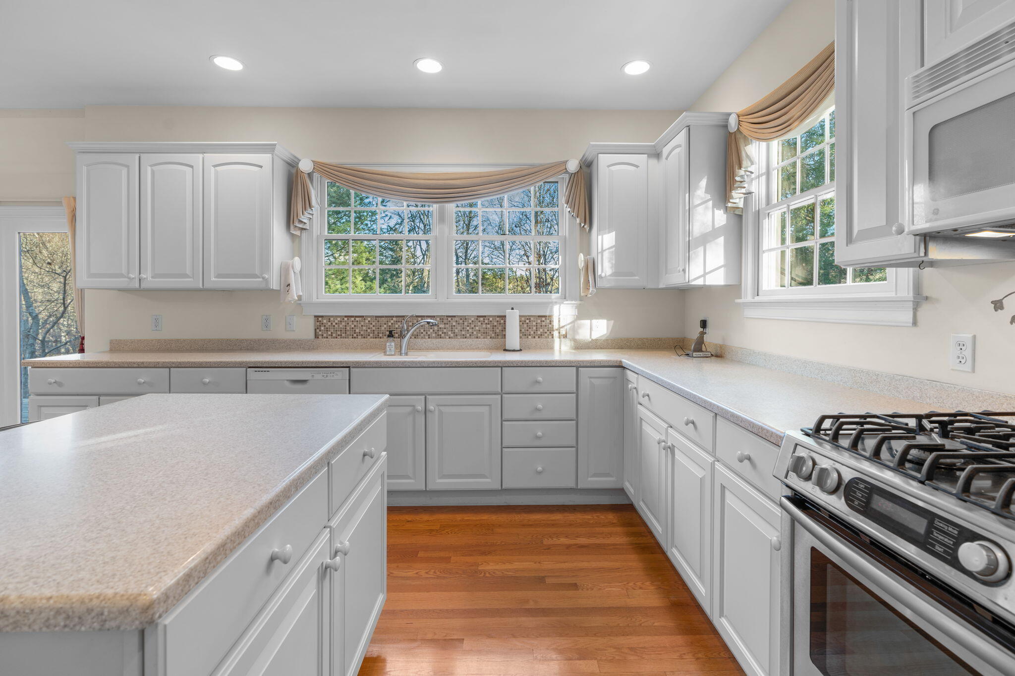 208 Rock Landing Road Mashpee, MA 02649 - Photo 4 of 32 a kitchen with wooden cabinets sink and stove