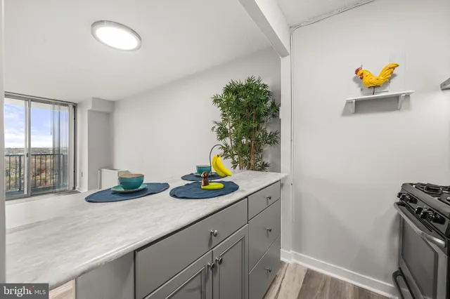a kitchen with a sink and a stove next to a window
