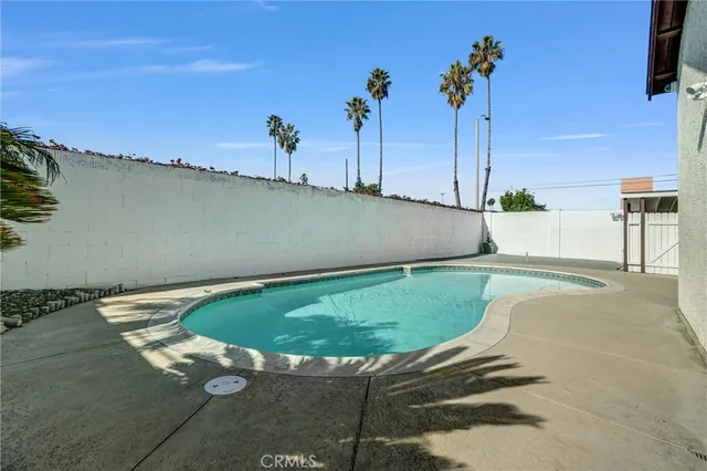 a view of a swimming pool with a yard