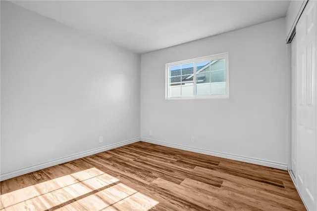 a view of a room with wooden floor and white walls