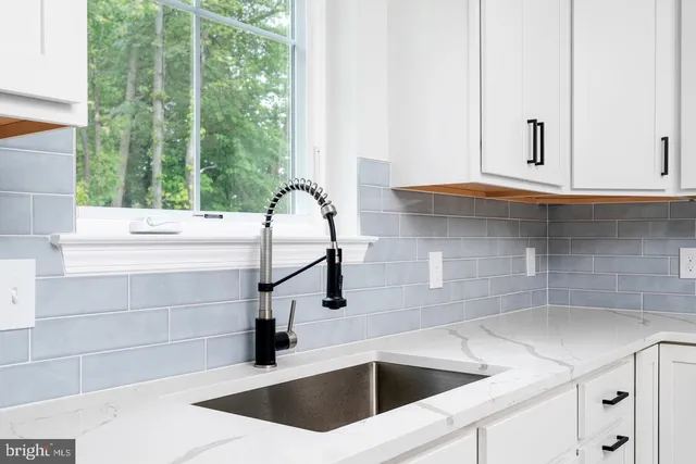 a kitchen with a sink and large window
