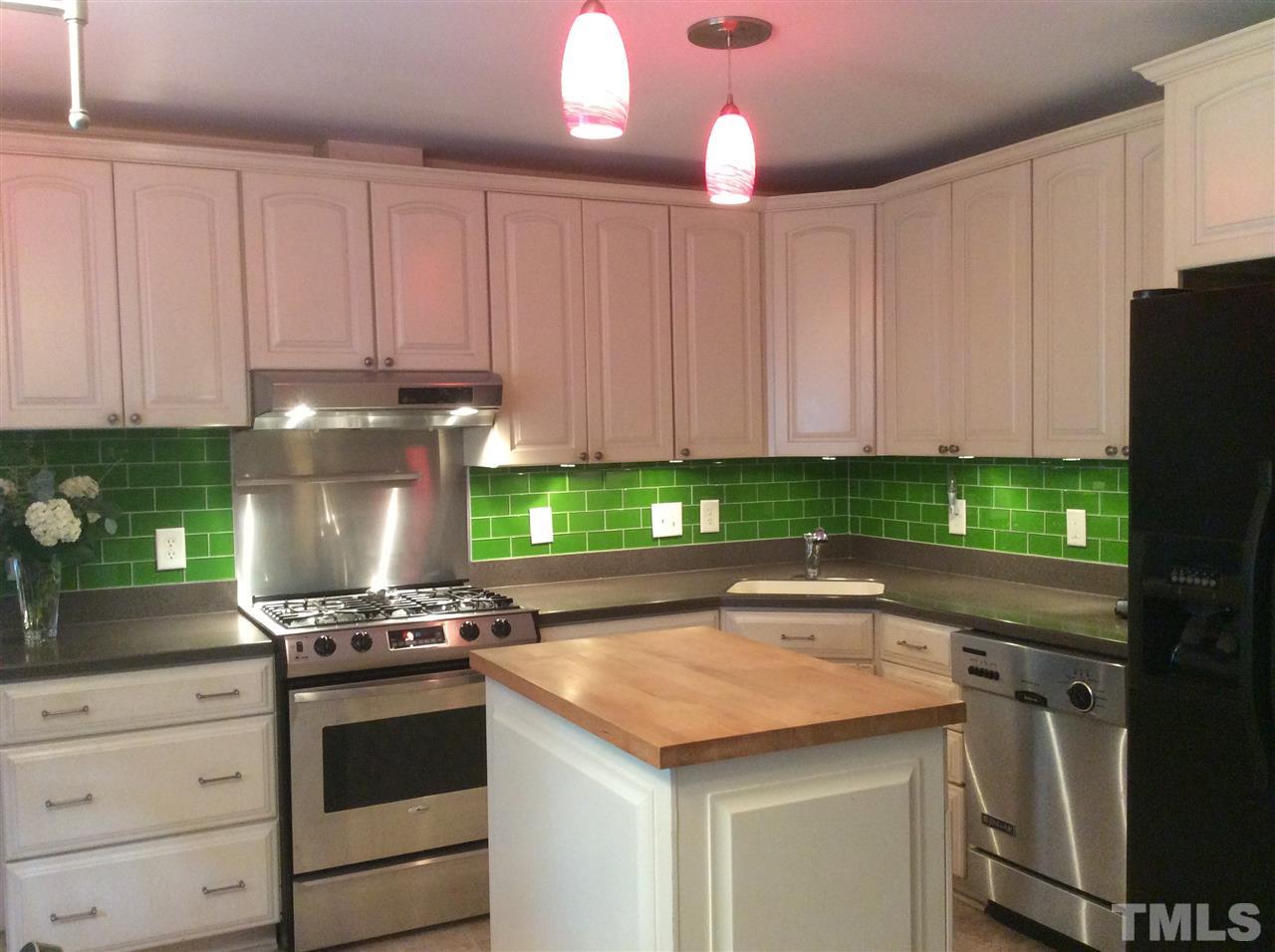1013 Deerfield Road Raleigh, NC 27609 - Photo 2 of 25 a kitchen with granite countertop a stove and a white refrigerator